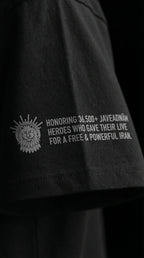 Black t-shirt sleeve with lion emblem and text honoring 36,500+ Javeadnām heroes for a free Iran