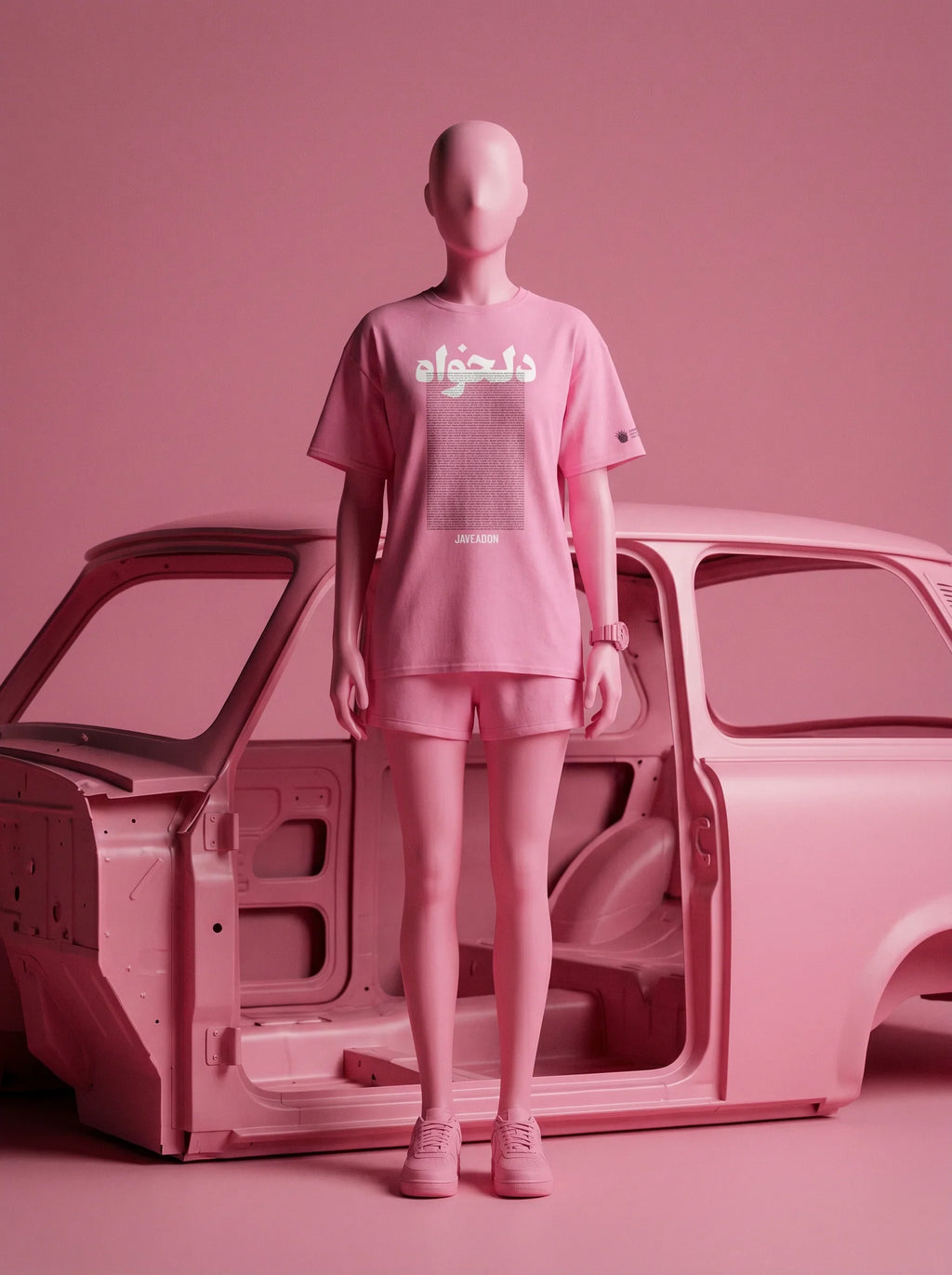 Pink streetwear set with Persian script tee and shorts, styled with car body in monochrome pink studio
