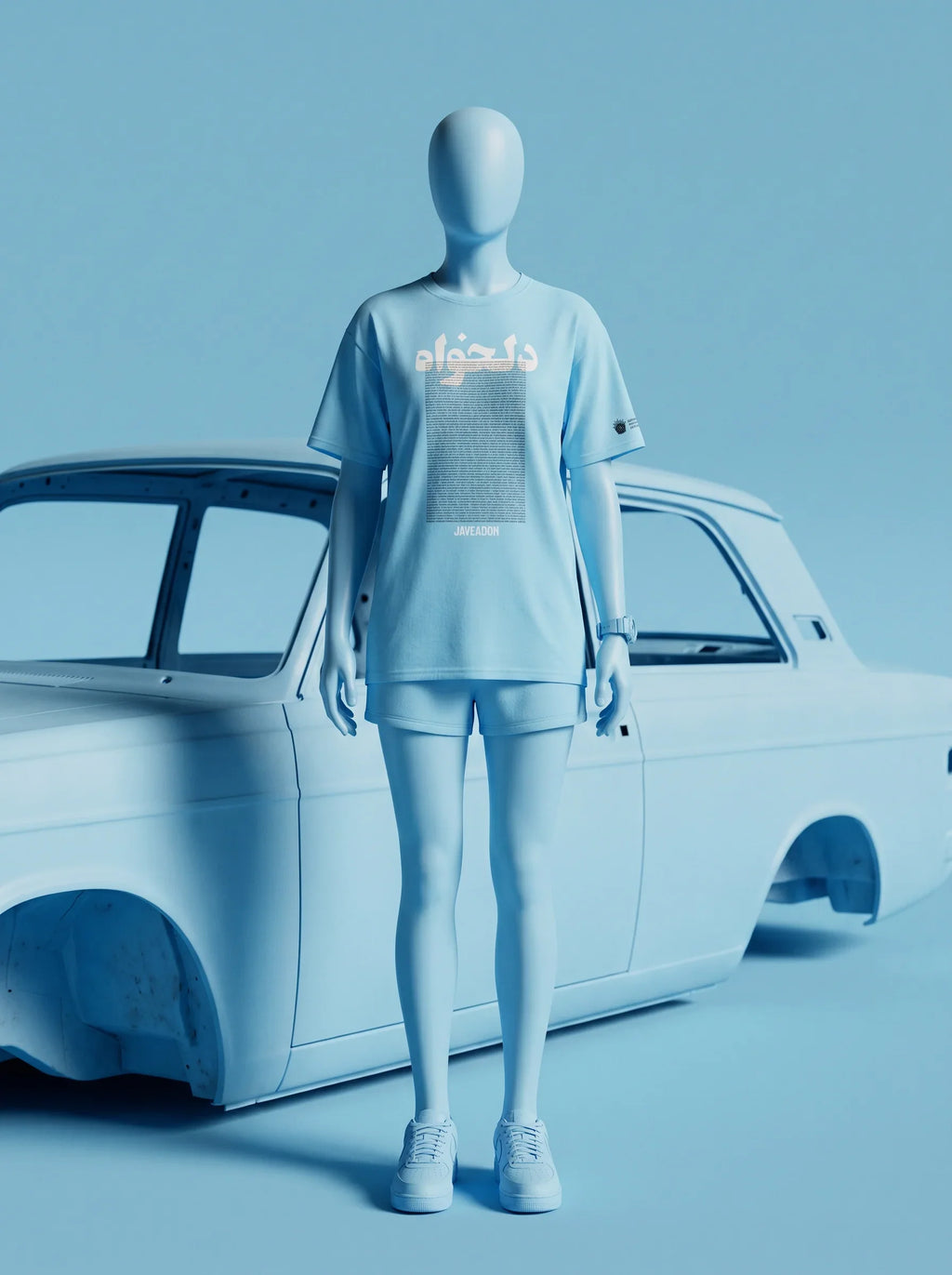 Light blue streetwear outfit with Persian-inspired design, paired with sneakers, styled beside a classic car.