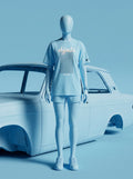 Light blue streetwear outfit with Persian-inspired design, paired with sneakers, styled beside a classic car.