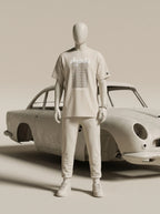 White streetwear outfit with Persian-inspired design, paired with classic car backdrop