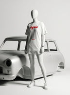 White t-shirt with Persian text and 'Javeadon' branding, styled with shorts and sneakers beside a classic car.
