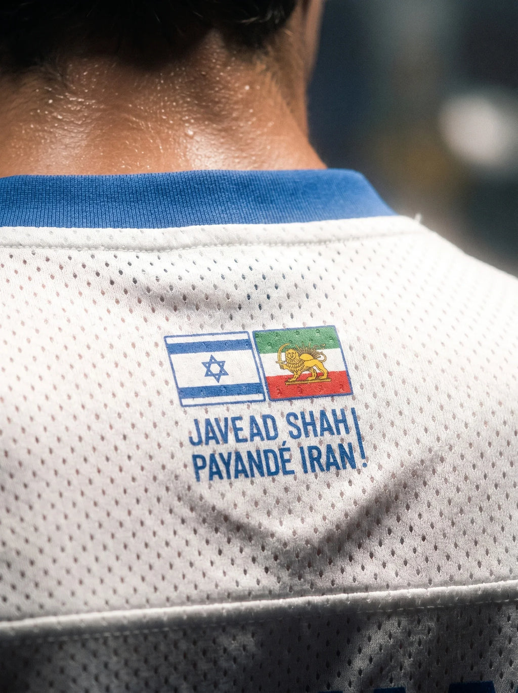 White mesh jersey with Israel and Persian Lion & Sun flags, text 'Javead Shah Payandé Iran!' on back